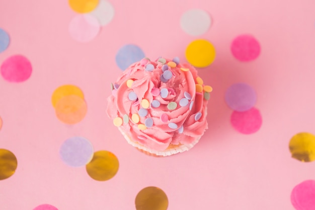 Free Photo top view pink birthday cupcake