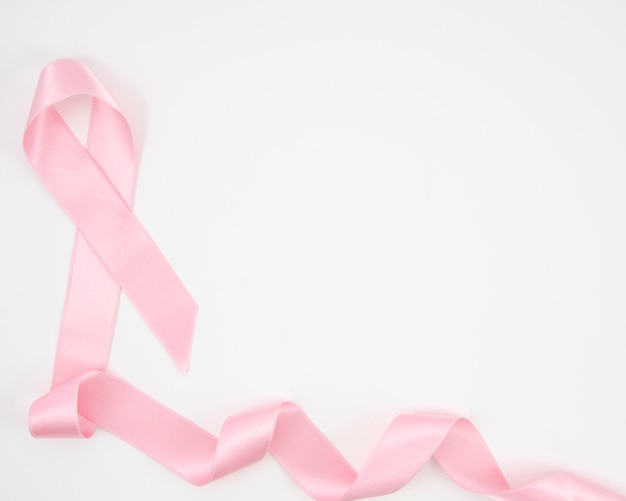 Free photo top view pink ribbon on white background