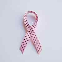 Free photo top view pink ribbon with black dots