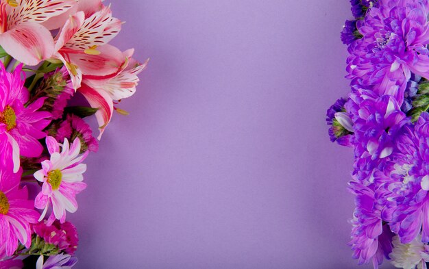 Top view of pink white and purple color statice alstroemeria and chrysanthemum flowers on lilac background with copy space