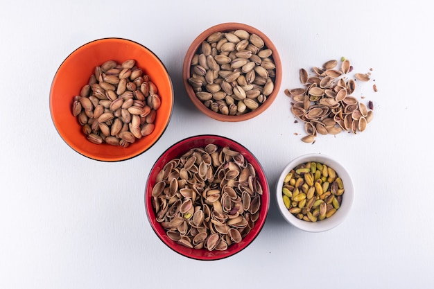 Free Photo top view pistachios in a bowls on white  horizontal