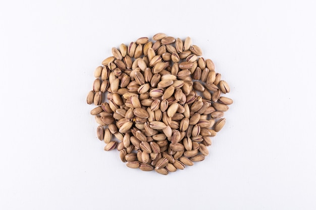 Top view pistachios circle shaped on white  horizontal