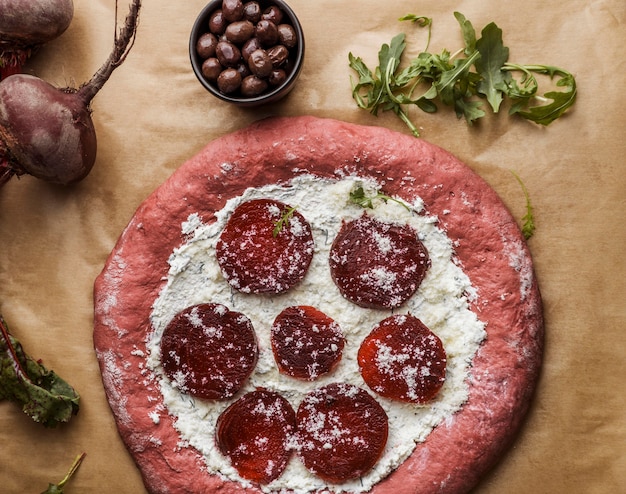 Free photo top view of pizza dough with beet slices