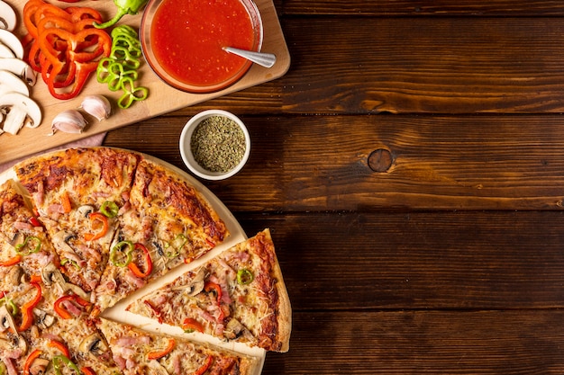 Top view pizza with red pepper and tomato sauce with copy-space