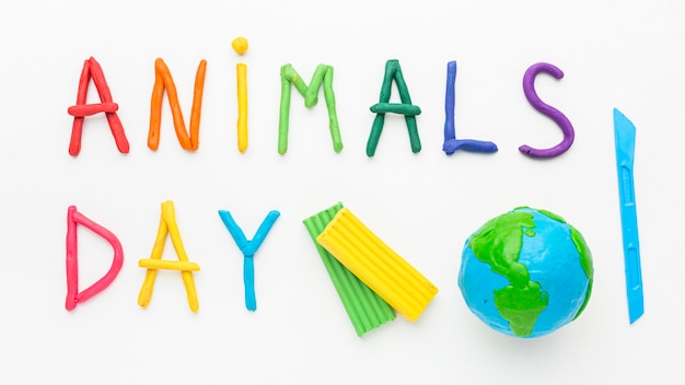 Free Photo top view of planet earth and colorful writing for animal day