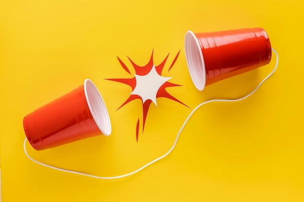 Top view of plastic cups attached with string and paper shape