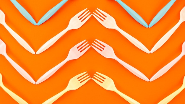 Free photo top view of plastic fork on orange background