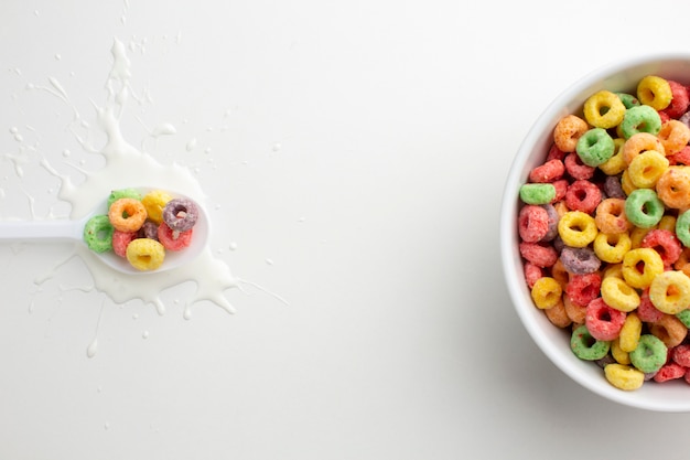 Top view plastic spoon and cereal bowl