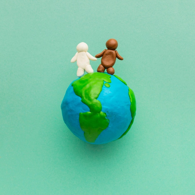 Free photo top view of plasticine globe and people