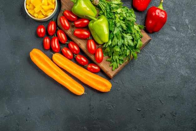 Top view of plate stand with vegetables over and near to it with free place for your text on dark grey background