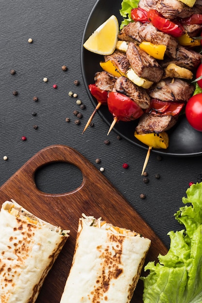 Free photo top view of plate with delicious kebab and salad