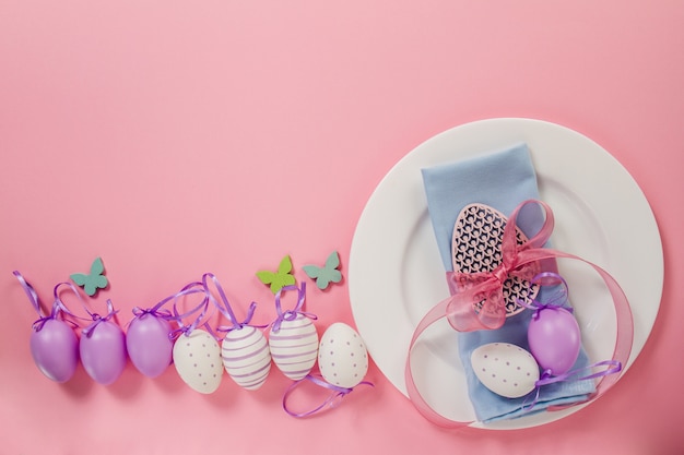 Top view of plate with easter eggs and butterflies