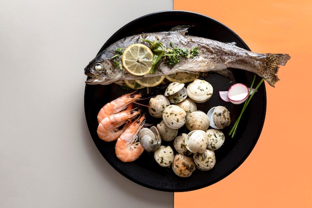 Top view of plate with fish and clams