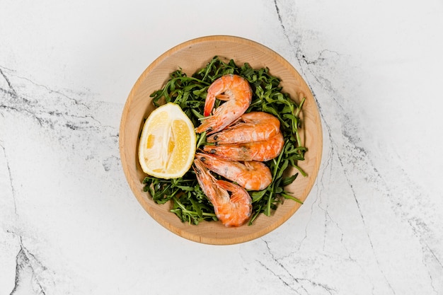 Top view of plate with salad and shrimp