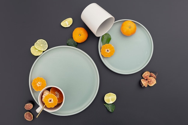 Free photo top view of plate with tangerine slices and figs