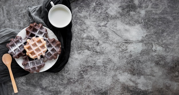 Top view of plate with waffles covered in powdered sugar