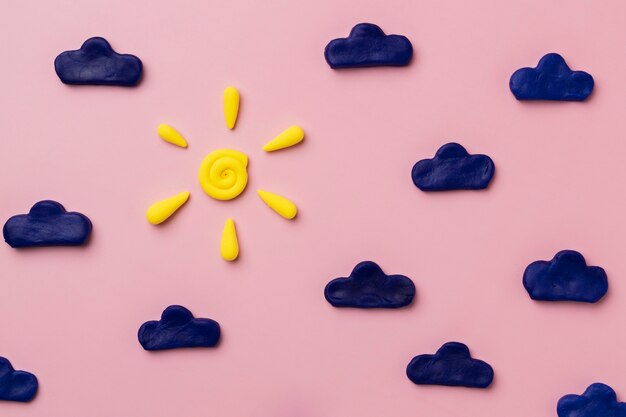 Top view play dough clouds and sun