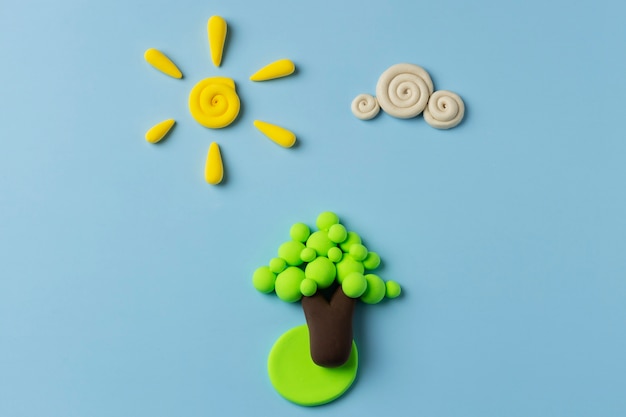 Free Photo top view play dough sun, cloud and tree