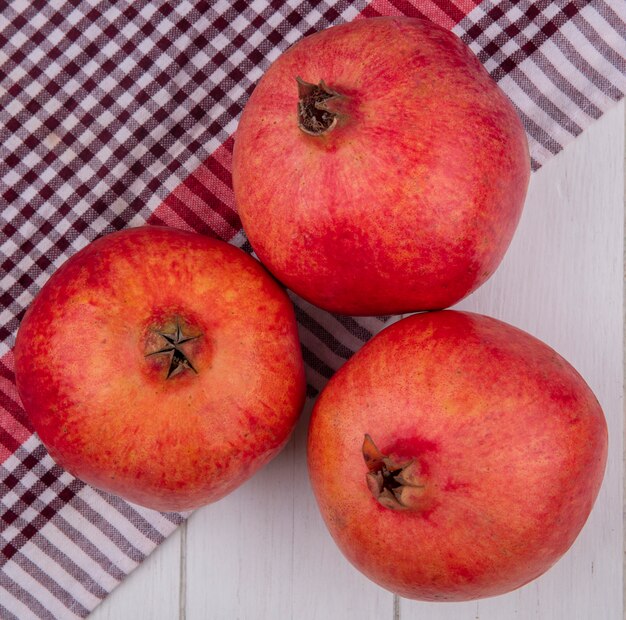 Top view of pomegranate on a red checkered towel