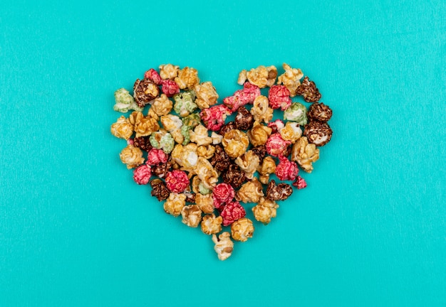 Top view of popcorn heart on blue  horizontal