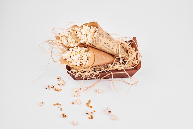 Top view of popcorn wrapped inside paper on white isolated.