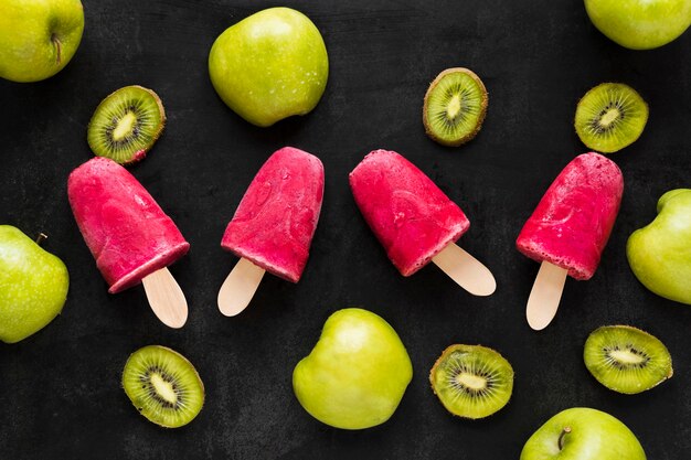 Top view of popsicles with kiwi and apple