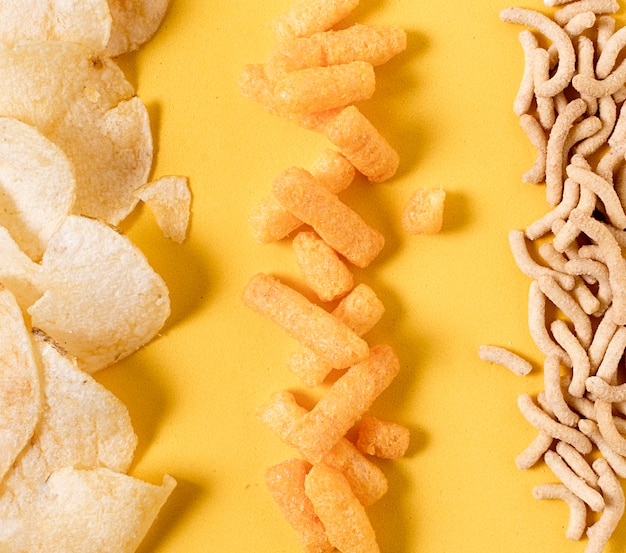 Free Photo top view of potato chips and cheesy puffs