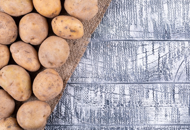 Top view potatoes on gray wooden table