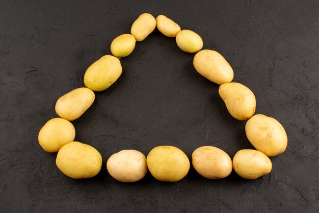 top view potatoes whole triangle shaped on the dark background