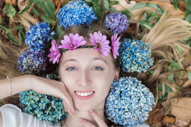 Top view of pretty girl surrounded by flowers