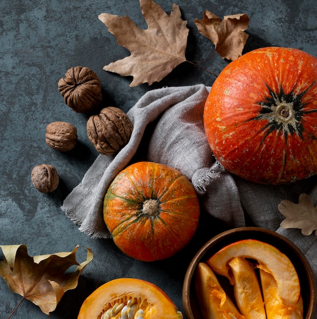 Free Photo top view pumpkins and nuts arrangement