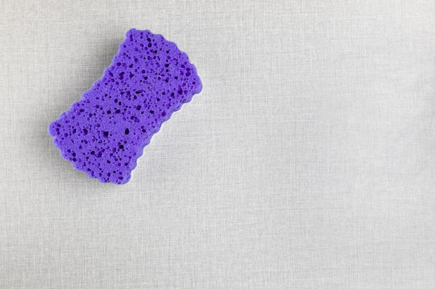 Top view purple sponge on grey background