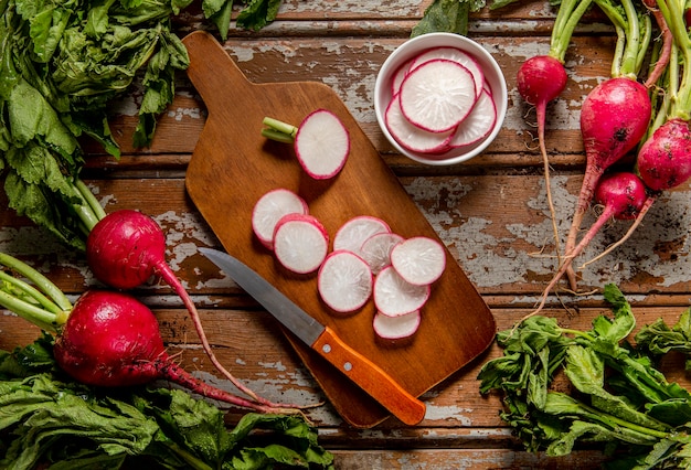 Top view of radishes with knife