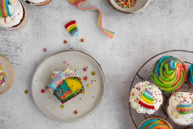 Free Photo top view rainbow cupcakes still life