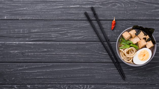 Top view ramen healthy soup with egg and chopsticks