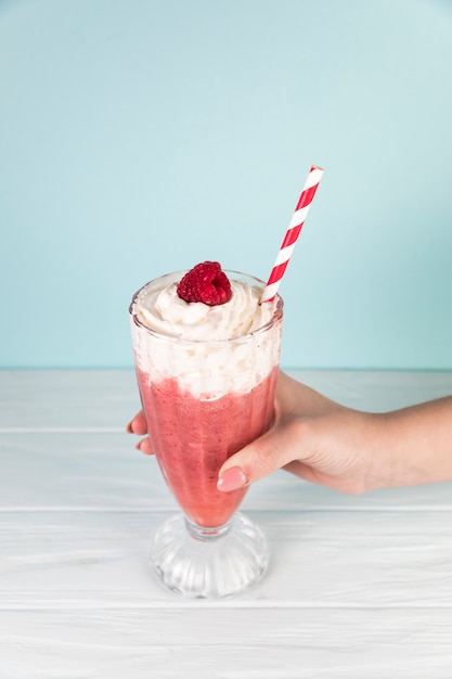 Free photo top view raspberry milkshake glass