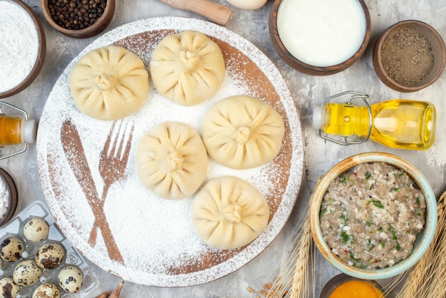 Top view raw little dumplings with seasonings and eggs on white background pie color bake cake dough salad meat food