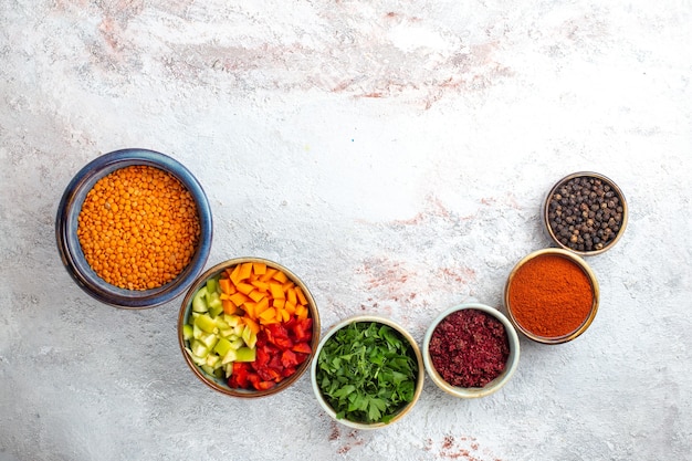 Top view raw orange beans with seasonings on light white surface meal bean merci vegetable ingredient