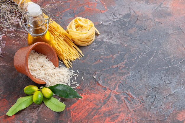 Top view raw pasta with rice on dark surface raw dough pasta