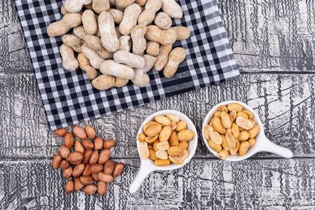 Top view raw peanuts on table cloth on wooden  horizontal