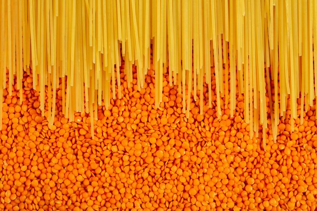 Top view of raw spaghetti on red lentils