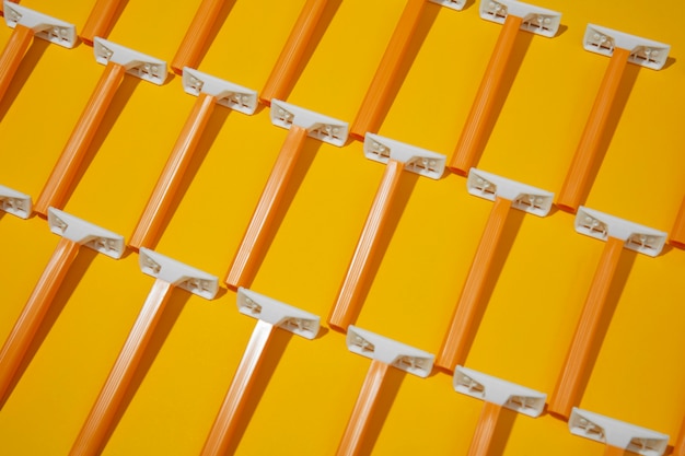 Top view razor blades with yellow background