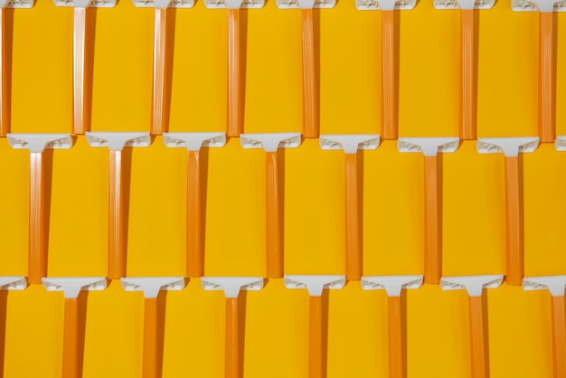 Top view razor blades with yellow background