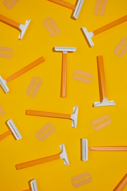 Top view razor blades with yellow background