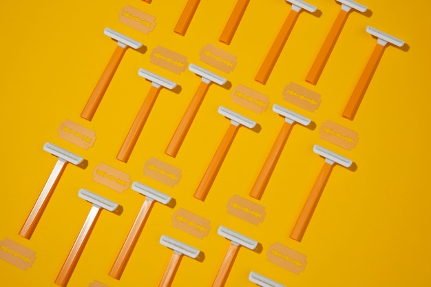 Free Photo top view razor blades with yellow background