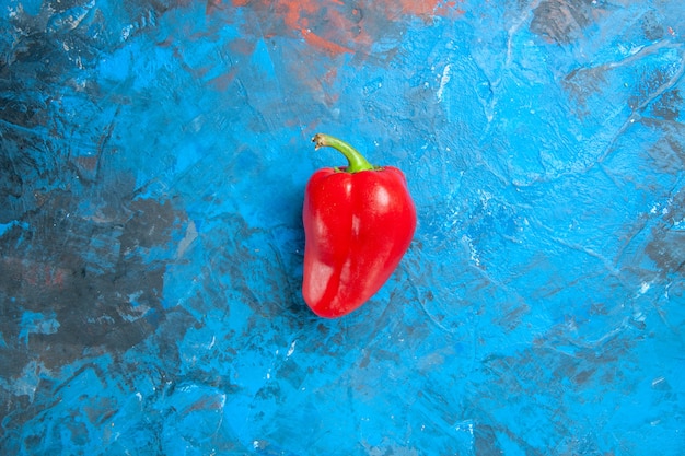 Top view of red bell-pepper on blue surface