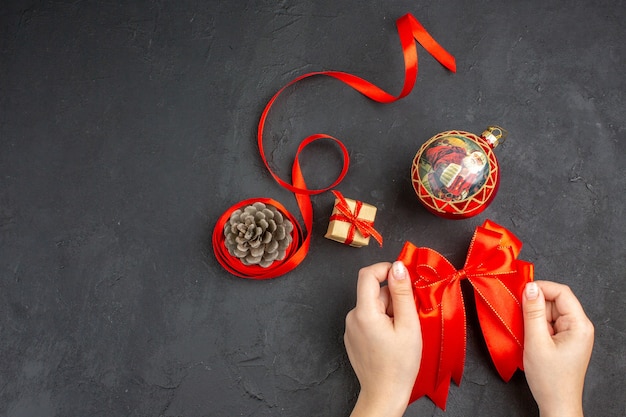 Top view red bow xmas ornaments on beige background