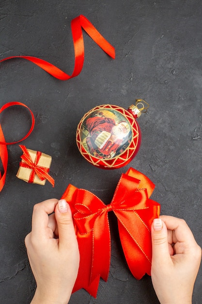 Top view red bow xmas ornaments on beige background