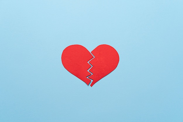 Free Photo top view red broken heart on blue background