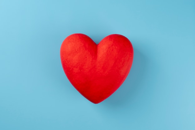 Free photo top view red heart on blue background